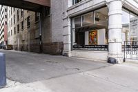 an empty building with a very big open window, a trash can and other items