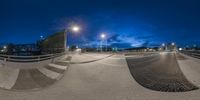 this is an upside down view of a skateboard park at night, with blue sky and clouds