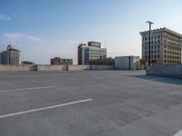 several large empty parking spaces in the city with buildings nearby in front of them -