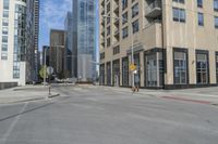 a view of the street with some tall buildings and the sky behind it on this sunny day