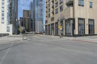 a view of the street with some tall buildings and the sky behind it on this sunny day