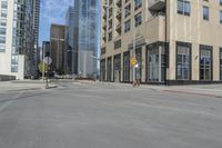 a view of the street with some tall buildings and the sky behind it on this sunny day