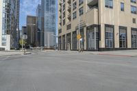 a view of the street with some tall buildings and the sky behind it on this sunny day