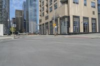 a view of the street with some tall buildings and the sky behind it on this sunny day