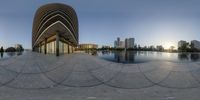 a circular reflection image with the city in the background of it and a large pool