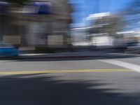 people are walking down the road near a store with blue and white awnings