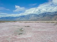 a vast area with mountains in the distance and water on it's sides, as if painted by salt and mud