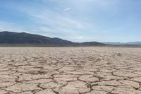 the sun is shining on dry ground in the middle of nowhere and no clouds in the sky