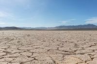 the sun is shining on dry ground in the middle of nowhere and no clouds in the sky