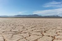 the sun is shining on dry ground in the middle of nowhere and no clouds in the sky