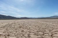 the sun is shining on dry ground in the middle of nowhere and no clouds in the sky