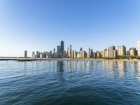 the city skyline is behind a wide body of water in chicago harbor, illinois, usa