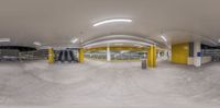 a 360 - angle photograph of a parking garage with lots of space to move around