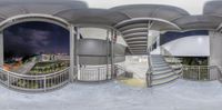 a 360 - camera photo of a man walking down stairs near a staircase way by a building