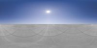 the sun shines over a vast open desert area with thin lines made of ropes