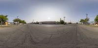 a view of a street through a fisheye lens of cars passing by on the road