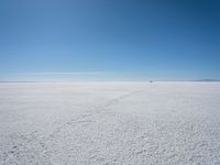 the view from the top of a salt flat in a deserted area with an distant mountain range in the distance