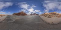 the 3d view shows the road in a barren environment, the sky and mountains are visible in the background