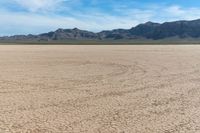 dry desert and mountain scenery under a clear sky on an island of land with arid land