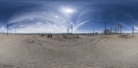 an empty dirt lot has been built into a circular panorama view and is in the desert