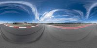 a view from a 3d rendering of a curved racetrack with a sky background behind it