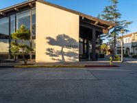 a street corner with sidewalk and building next to it in san mateo, california in the afternoon