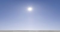 the sun shines brightly on an icy field of water, surrounded by snow covered mountains