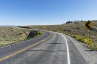 a curve sign is shown on the side of a road in the middle of nowhere