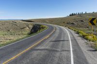 a curve sign is shown on the side of a road in the middle of nowhere