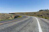 a curve sign is shown on the side of a road in the middle of nowhere