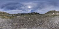 a photo taken from a virtualized picture shows the mountain landscape and sky with a full moon in the distance