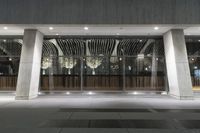 a hotel's entrance at night with lights in it and a sign out front