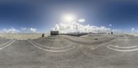 the view from a parking lot looking at an industrial area with many pipes and machinery