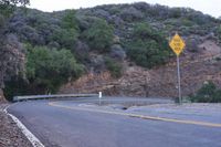 a sign warns the curve is an incline or road over and below the hill and down to where it is