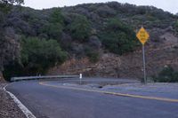 a sign warns the curve is an incline or road over and below the hill and down to where it is