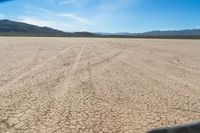 the desert is dirty and it looks as if it are going down a mountain