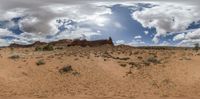 an image of desert land with blue sky and clouds overhead in 3d style as seen through a fish eye lens