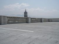 a parking lot and wall are pictured in a photo from the perspective point of view