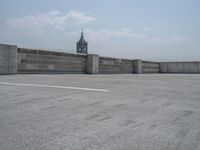 a parking lot and wall are pictured in a photo from the perspective point of view