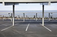 a parking lot with rows of solar panels mounted on the side of the building with street light