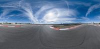 there is a panoramic view of the road and sky from inside the car