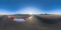 an upside down picture shows a racing track in the background, and the sun shining