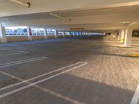 there is a large empty parking garage in a building with no people around the car port