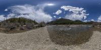 a panoramic shot of a river and mountains in the background under clouds, and an upside down view of water,