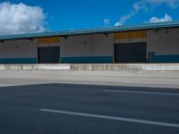 an empty lot with an empty parking lot in the background and clouds in the distance