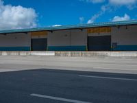 an empty lot with an empty parking lot in the background and clouds in the distance