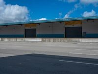 an empty lot with an empty parking lot in the background and clouds in the distance