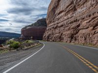 the winding road runs through a mountainous area in utah usa, along with many rocky cliffs, mountains and river