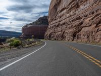 the winding road runs through a mountainous area in utah usa, along with many rocky cliffs, mountains and river