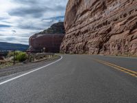 the winding road runs through a mountainous area in utah usa, along with many rocky cliffs, mountains and river